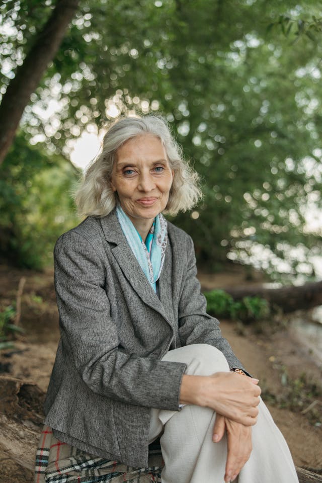 Photo by Anastasia Shuraeva: https://www.pexels.com/photo/woman-in-gray-blazer-sitting-on-tree-trunk-8796054/